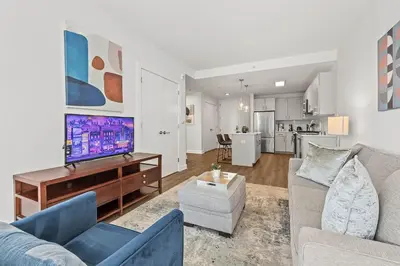 a living room with a couch and a tv at Luxury Modern Apartment Near Stamford Station in Stamford