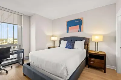 a bedroom with a bed and a desk with a computer at Luxury Urban Escape Walk to Downtown in Stamford