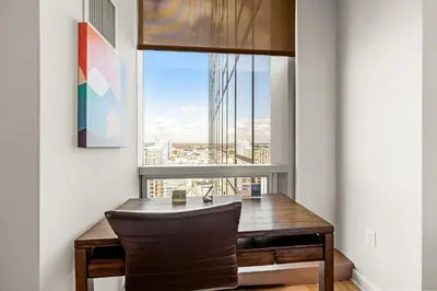 a dining room with a table and a large window at Luxury Urban Escape Walk to Downtown in Stamford