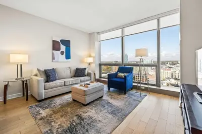 a living room with a couch and a blue chair at Luxury Urban Escape Walk to Downtown in Stamford