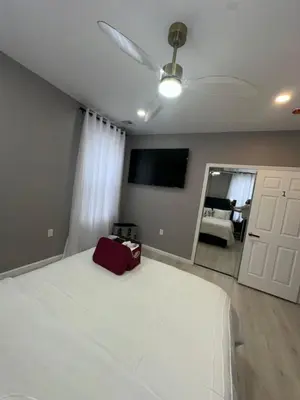 a bedroom with a white bed and a ceiling fan at 3 Large Bedroom Designer house Spacious in Newark