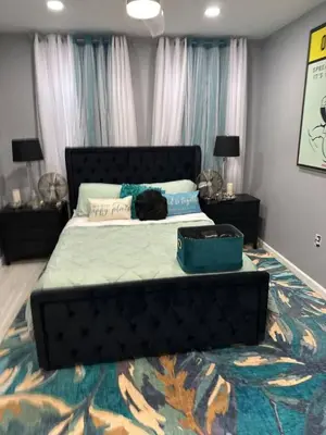 a black cat laying on a bed in a bedroom at 7 Large Bedrooms Art-Inspired Art House in Newark