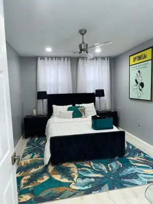 a bedroom with a large bed and a rug at 7 Large Bedrooms Art-Inspired Art House in Newark