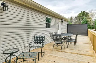 a wooden deck with chairs and a table and a table and chairs at 8 Mi to Jiminy Peak Resort Mtn-View Home with Deck in Stephentown