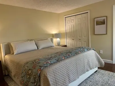 a bedroom with a bed and a white door at In the middle of everything in Saratoga Springs