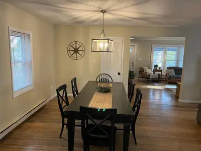 a dining room and living room with a table and chairs at In the middle of everything in Saratoga Springs