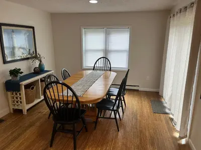 a dining room with a wooden table and chairs at In the middle of everything in Saratoga Springs
