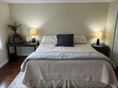a bedroom with a large bed with two lamps at In the middle of everything in Saratoga Springs