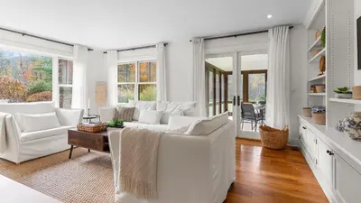 a white living room with white furniture and windows at Modern Berkshires Farmhouse w Porch Fireplace Views Beaver Creek by AvantStay in Stockbridge