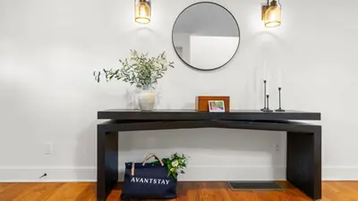 a bathroom with a black console table with a mirror at Modern Berkshires Farmhouse w Porch Fireplace Views Beaver Creek by AvantStay in Stockbridge