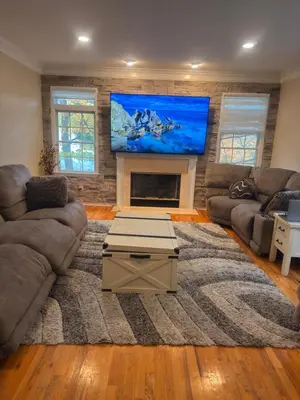 a living room with a large flat screen tv at villa in North Haledon