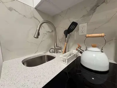 a kitchen counter with a sink and a tea kettle at Room in Chelsea 2 with Kitchen - Shared Bathroom -5th Floor Walk-UP in New York