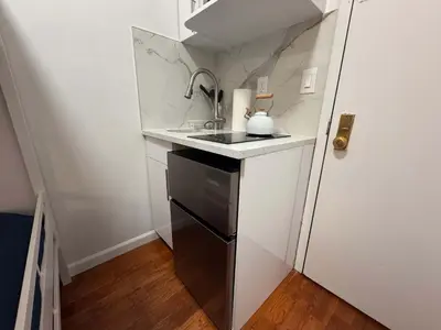 a small kitchen with a sink and a dishwasher at Room in Chelsea 2 with Kitchen - Shared Bathroom -5th Floor Walk-UP in New York