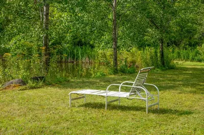a bench sitting in the grass in a field at Bootleg Hollow in Andes