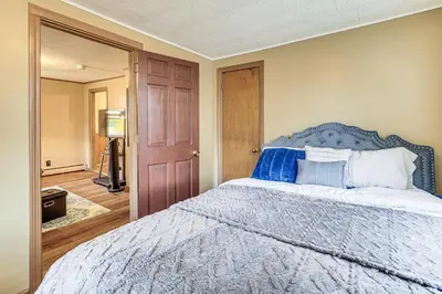 a bedroom with a blue bed with blue pillows at 1 Mi to Main St Riverside Torrington Apt with Yard in Torrington