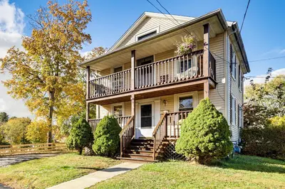 a large house with a balcony and stairs at 1 Mi to Main St Riverside Torrington Apt with Yard in Torrington