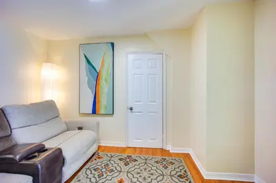 a living room with a couch and a door at Riverfront Apt with Fire Pit and Yard in Millers Falls