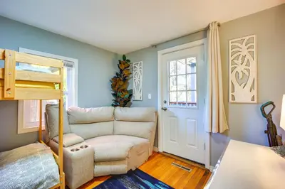 a room with a bed and a couch and a chair at Riverfront Apt with Fire Pit and Yard in Millers Falls