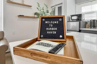 a wooden tray with a book and a remote control in a kitchen at Harbor Haven, Apt #1 Studio in Stamford