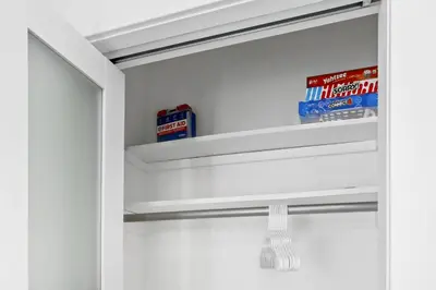 a closet with white walls and white shelves at Harbor Haven, Apt #1 Studio in Stamford