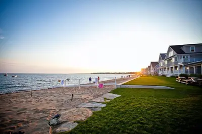 a group of people standing on a beach near the water at Harbor Haven, Apt #1 Studio in Stamford