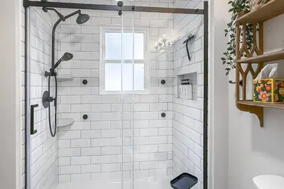a white bathroom with a shower with a window at Plymouth Court Turret Retreat in Milford