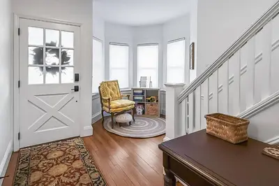 a living room with a chair and a door at Plymouth Court Turret Retreat in Milford