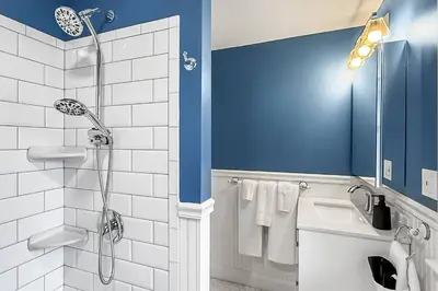 a bathroom with a shower and a sink with towels at Plymouth Court Turret Retreat in Milford