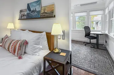 a bedroom with a bed and a desk and a piano at Plymouth Court Turret Retreat in Milford