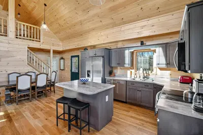 a kitchen and dining room of a log cabin at Peaceful Lakefront Cabin in the Catskills cabin in Athens