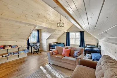 a living room with a couch and wooden ceilings at Peaceful Lakefront Cabin in the Catskills cabin in Athens