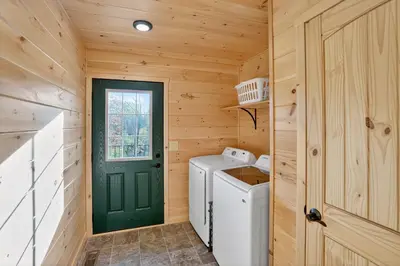 a wooden laundry room with a washer and dryer at Peaceful Lakefront Cabin in the Catskills cabin in Athens