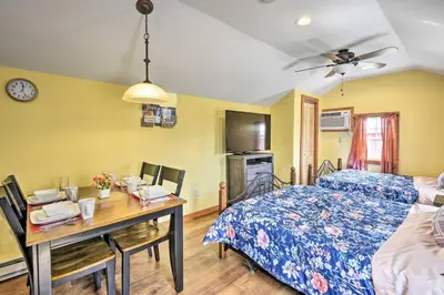 a bedroom with a bed and a desk with a table at Log Cabin and Suites Close to Elk Mountain Ski Resort in Pleasant Mount