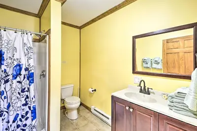 a bathroom with a sink and a toilet and a mirror at Wander & Unwind, Log Cabin and Suites Close to Ski Mountain in Pleasant Mount