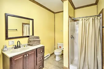 a bathroom with a sink and a toilet and a mirror at Family Suites Close to Elk Mountain Ski Resort in Pleasant Mount