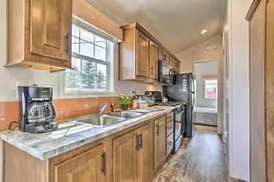 a kitchen with a sink and a refrigerator at Tranquil Trails Cabin & Suites Near Ski Area in Pleasant Mount