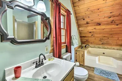 a bathroom with a sink and a toilet and a tub at Log Cabin and Cottage Near Elk Mountain Ski Slopes in Pleasant Mount