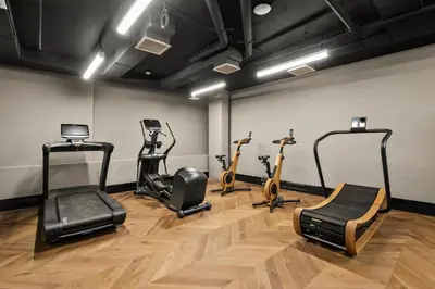 a gym with treadmills and exercise bikes in a room at Freeman 303 by Rove Travel - 1BR Condo with Shared Amenities in New York
