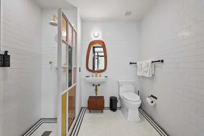 a white bathroom with a sink and a toilet at Freeman 501 by Rove Travel - Studio with Shared Amenities in New York