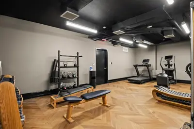 a room with a gym with benches and equipment at Freeman 701 by Rove Travel - Studio with Shared Amenities in New York