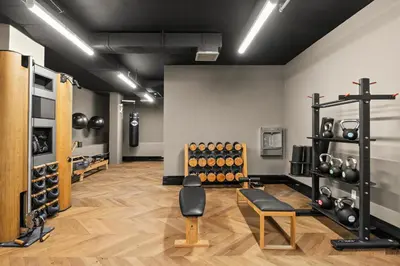 a room with a gym with dumbbells on the wall at Freeman 1001 by Rove Travel - Studio with Shared Amenities in New York