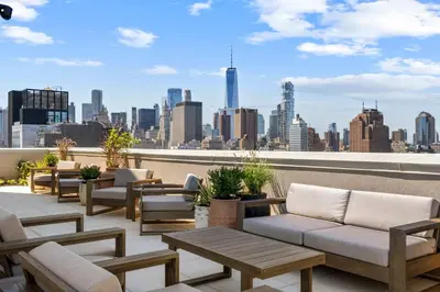 a rooftop patio with couches and a view of the city at Freeman 1001 by Rove Travel - Studio with Shared Amenities in New York