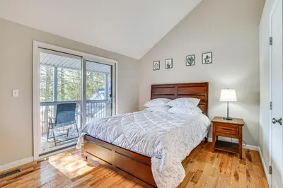 a bedroom with a bed and a large window at Steps to Lake Tanglwood Tranquil Wooded Retreat in Greentown