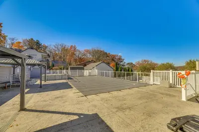 a patio with a white fence and a playground at Steps to Lake Tanglwood Tranquil Wooded Retreat in Greentown