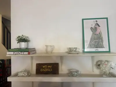a shelf with a picture of a woman on it at Blue Bird Chalet 5BR with Sauna near Skiing in East Chatham