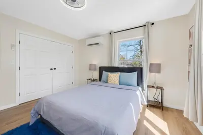 a white bedroom with a large bed and a window at Spacious 5BR Home KING Bed Wi-Fi Parking in Bloomfield