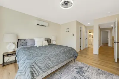 a bedroom with a large bed and a hallway at Spacious 5BR Home KING Bed Wi-Fi Parking in Bloomfield