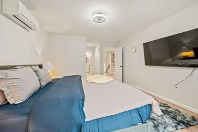 a bedroom with a large bed and a flat screen tv at Old, Unlisted in Bloomfield