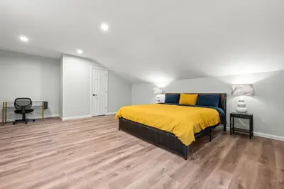 a bedroom with a bed with a yellow blanket at Old, Unlisted in Bloomfield