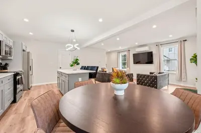 a kitchen and dining room with a wooden table and chairs at Old, Unlisted in Bloomfield